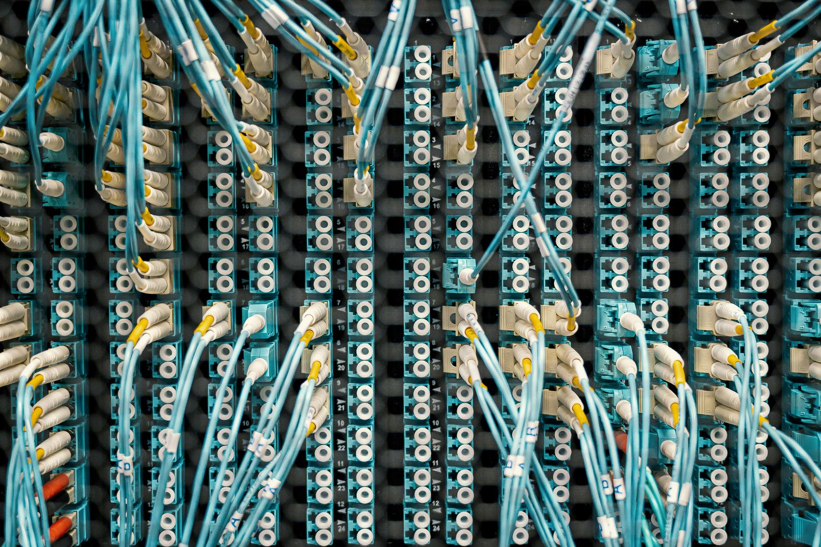 Dense network of data cables, representing fragmented health record systems with no unified connection